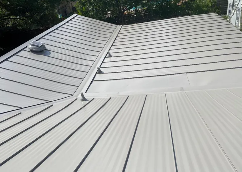 Solar attic fan installed on a metal roof for Roof Ventilation in Ottawa